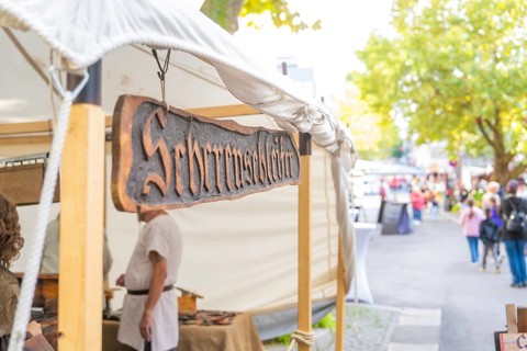 Sign above a market stall in a busy street, Sindelfingen, Böblingen district, Germany