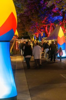 People walking at night on a street illuminated with colourful lights, Sindelfingen, Böblingen
