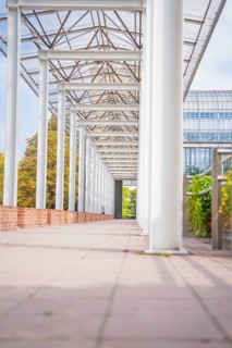 Modern colonnade with glass roof and plant environment, Munich, Germany