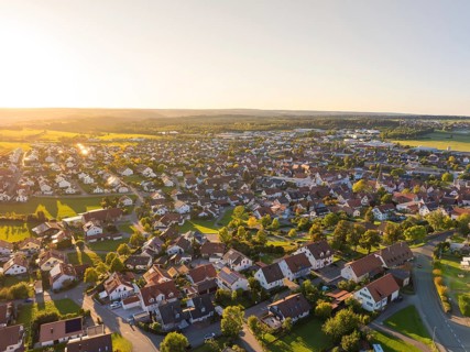 Aerial view of a village at sunset with densely built-up houses and rural flair, Althengstett,