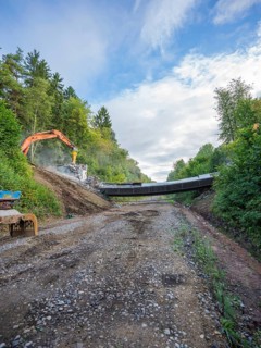 A wide path leads to a demolition site, excavator and fragments visible, bridge demolition, Calw,