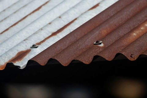 Close-up of a rusty, corrugated metal roof with brown and gray textures, Gazipur, bangladesh