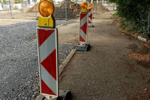 Borken, NRW, Germany, Red and white striped warning posts with flashing orange lights marking a