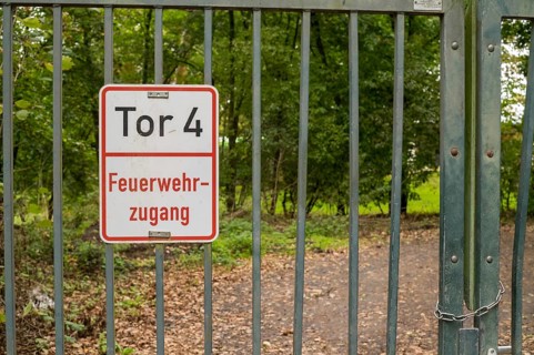 Borken, NRW, Germany, Metal gate displaying a feuerwehrzufahrt sign, providing entry to a forest