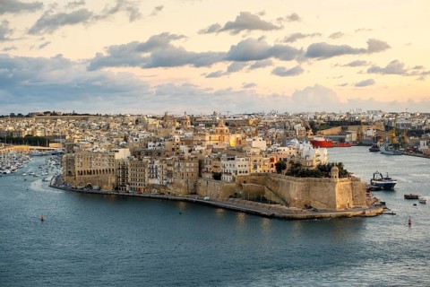 Beautiful sunset view of Valletta with Saint Angelo Fortress, capital city of Malta