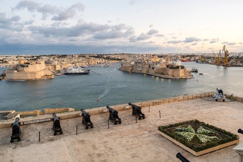 Beautiful sunset view of Valletta with a cannons in the foreground, capital city of Malta