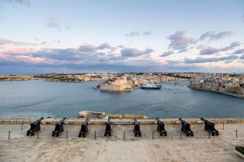 Beautiful sunset view of Valletta with a cannons in the foreground, capital city of Malta