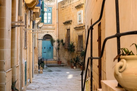 Street with amazing, wonderful historic houses with blue wooden balconies in La Valletta, capital