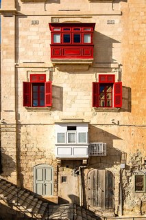 Amazing, wonderful historic houses with red wooden balconies in La Valletta, capital city of Malta
