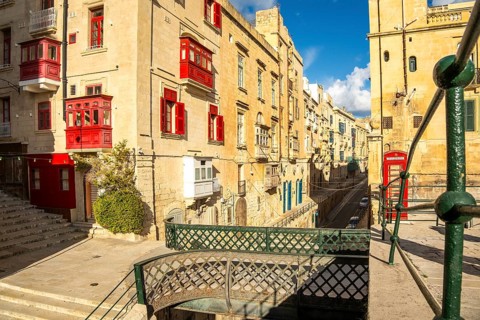 Street with incredible historic houses with colorful wooden balconies in La Valletta, capital city