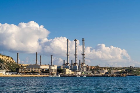 Waterfront power station against blue sky, with copy space, near to Marsaxlokk, Malta