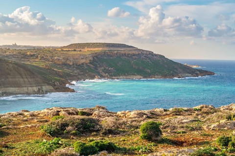 Beautiful view of Gozo coast seen from Ghar Mixta Cave, Malta