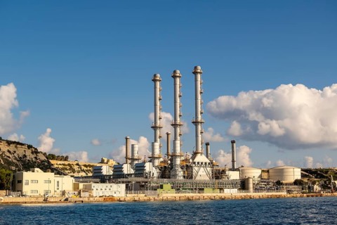 Waterfront power station against blue sky, with copy space, near to Marsaxlokk, Malta