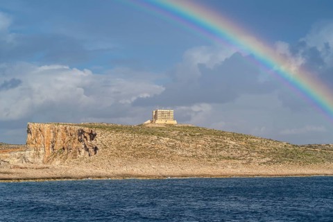 Amazing view of rainbow after the rain above Comino island, Malta