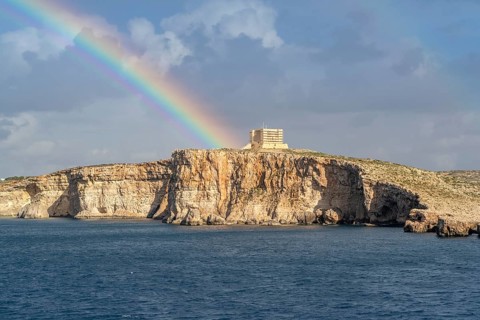 Amazing view of rainbow after the rain above Comino island, Malta
