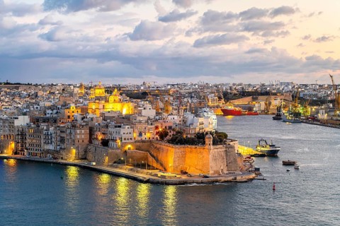 Beautiful evening view of illuminated Valletta, Birgu with Saint Angelo Fortress, capital city of
