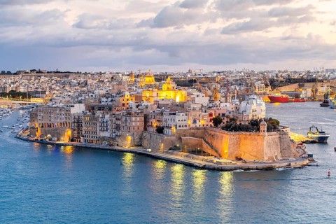Beautiful evening view of illuminated Valletta, Birgu with Saint Angelo Fortress, capital city of