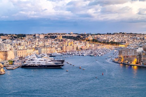 Beautiful evening view of illuminated Valletta, Birgu with Saint Angelo Fortress, capital city of
