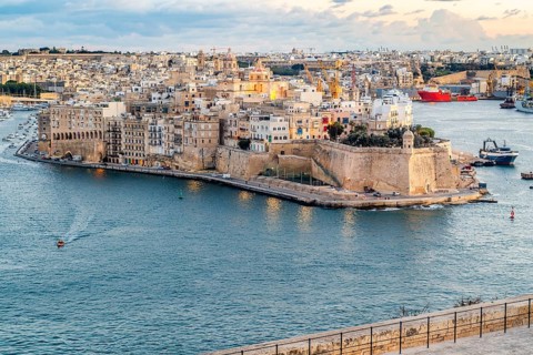Beautiful sunset view of Valletta city with Saint Angelo Fortress, capital city of Malta