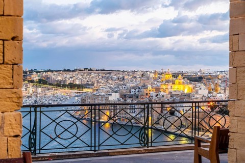 Beautiful evening view of illuminated Valletta, Birgu with Saint Angelo Fortress, capital city of