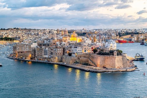 Beautiful evening view of illuminated Valletta, Birgu with Saint Angelo Fortress, capital city of