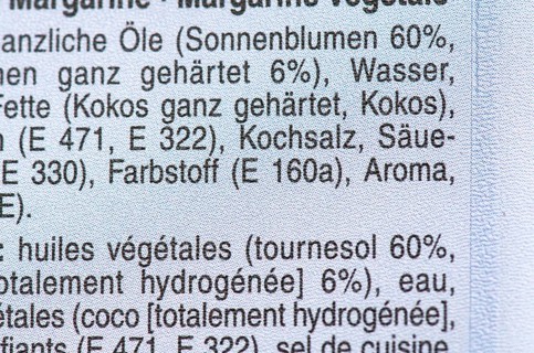 List of ingredients on a packet of margarine. Focus on coconut and E additives