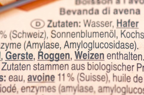 List of ingredients on a carton of oat milk. Focus on enzymes