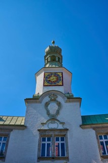 Tower clock on a historic building under a clear blue sky. Impressive baroque architecture,