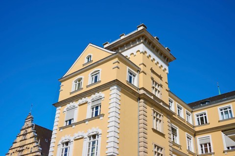 Historic building with yellow façade and decorative elements, Regensburg, Bavaria, Germany