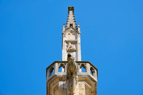 Detail of a Gothic spire with sculptures in the blue sky, St Peter's Cathedral, Regensburg,