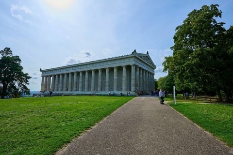 Large columned building stands at the end of a path, surrounded by green lawns, Walhalla,