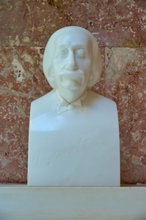 Albert Einstein, Humorous marble bust, classical style with friendly expression against a red