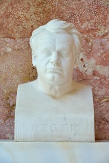 Serious marble bust of Max Reger against a red background, classical style, Walhalla, Donaustauf,