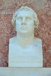 White marble bust of Martin Luther in front of a reddish wall, Walhalla, Donaustauf, Regensburg,