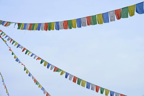 Colourful prayer flags flutter in the blue sky, conveying a feeling of freedom and peace, Bavaria,