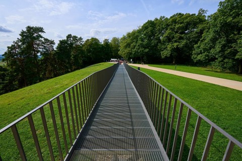 A metal bridge leads symmetrically towards a green wooded area, Walhalla, Donaustauf, Regensburg,