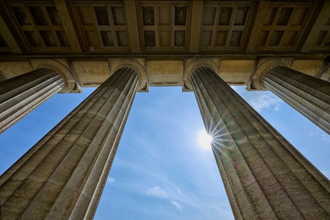 Classical stone pillars rise into the sky, pierced by rays of sunlight, Walhalla, Donaustauf,