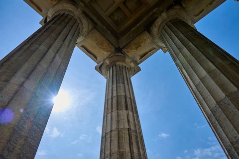 Majestic columns under a bright blue sky, seen from a low perspective, Walhalla, Donaustauf,