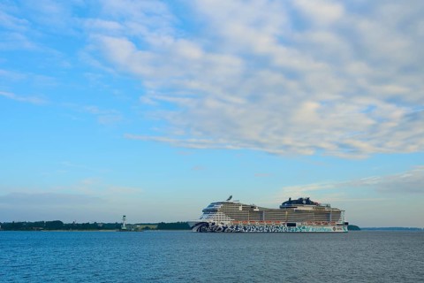 A cruise ship, MSC Euribia, moves through wide waters under a cloudy sky, Heikendorf, Plön