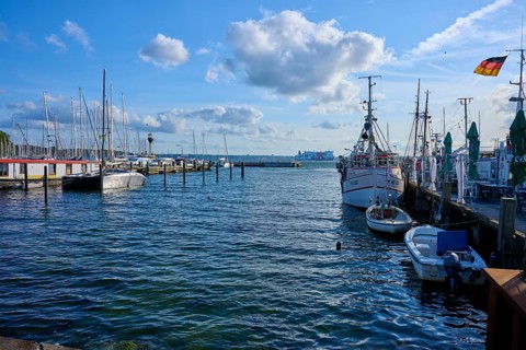 Harbour view with moored boats and blowing wind under a blue sky, Heikendorf, Plön district, Kiel