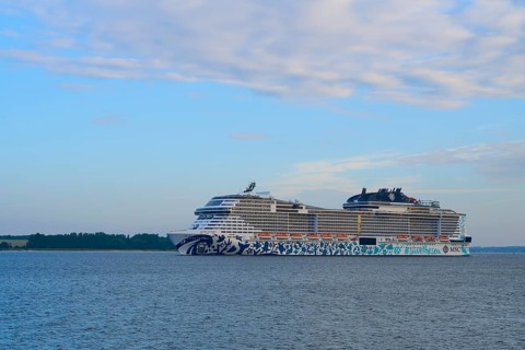 Cruise ship, MSC Euribia, gliding along in front of a wide water landscape, Heikendorf, Plön