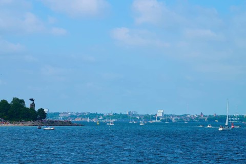 Sea view with sailing boats and a distant city of Kiel on the horizon, Heikendorf, Plön district,