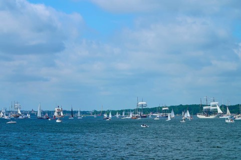 Boats and sailing ships sailing on the sea under a slightly cloudy sky, Windjammer Parade Kiel