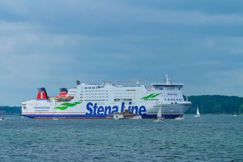 Stena Line ferry surrounded by sailing boats on the sea under a cloudy sky, Windjammer Parade Kiel