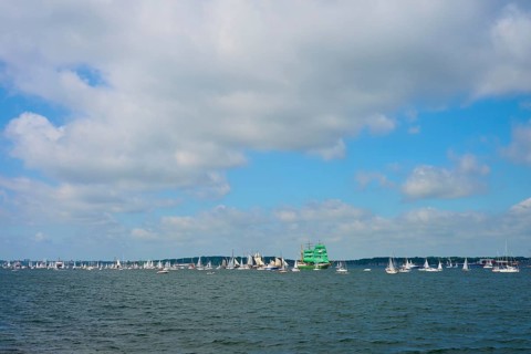 Numerous sailing boats on the sea under a slightly cloudy sky, Windjammer Parade Kiel 2025,