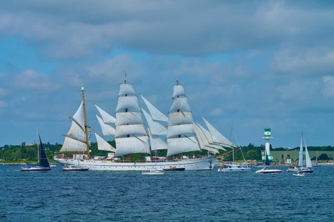 Large sailing ship Gorch Fock with several white sails on the sea under a blue sky, Windjammer