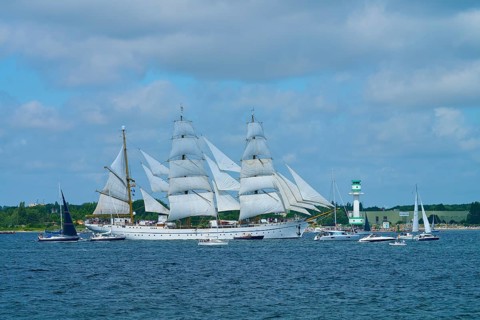 White sailing ship Gorch Fock on the sea with several big sails under blue sky, Windjammer Parade