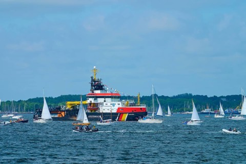 Various sailing boats and a large ship Arkona Coast Guard on a sunlit sea, Windjammer Parade Kiel