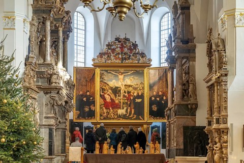 Three-panelled altarpiece Christ on the Cross by Lucas Cranach in the Stadtkirche St. Peter & Paul