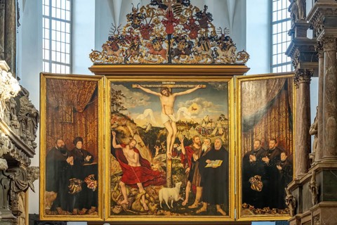 Three-panelled altarpiece Christ on the Cross by Lucas Cranach in the Stadtkirche St. Peter & Paul